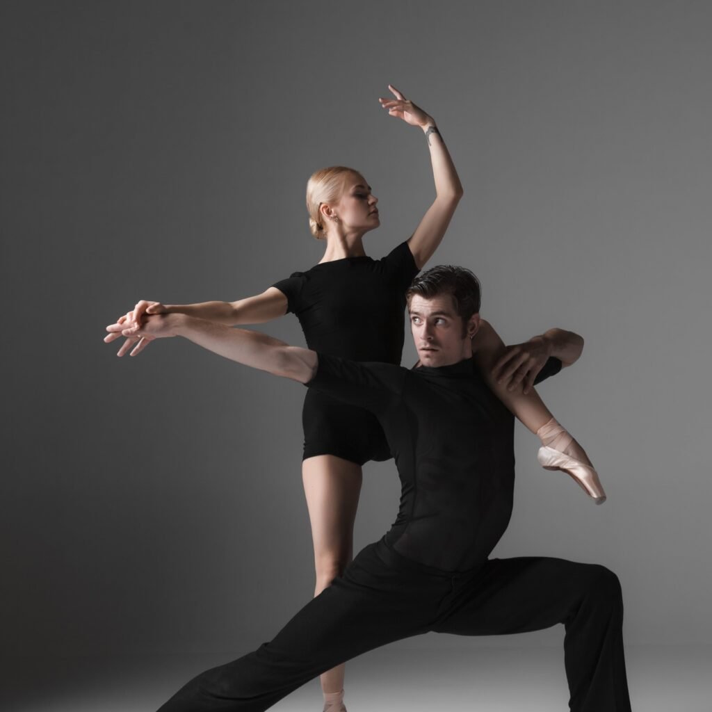 two-young-modern-ballet-dancers-on-gray-studio-bac-2023-11-27-05-18-39-utc-min